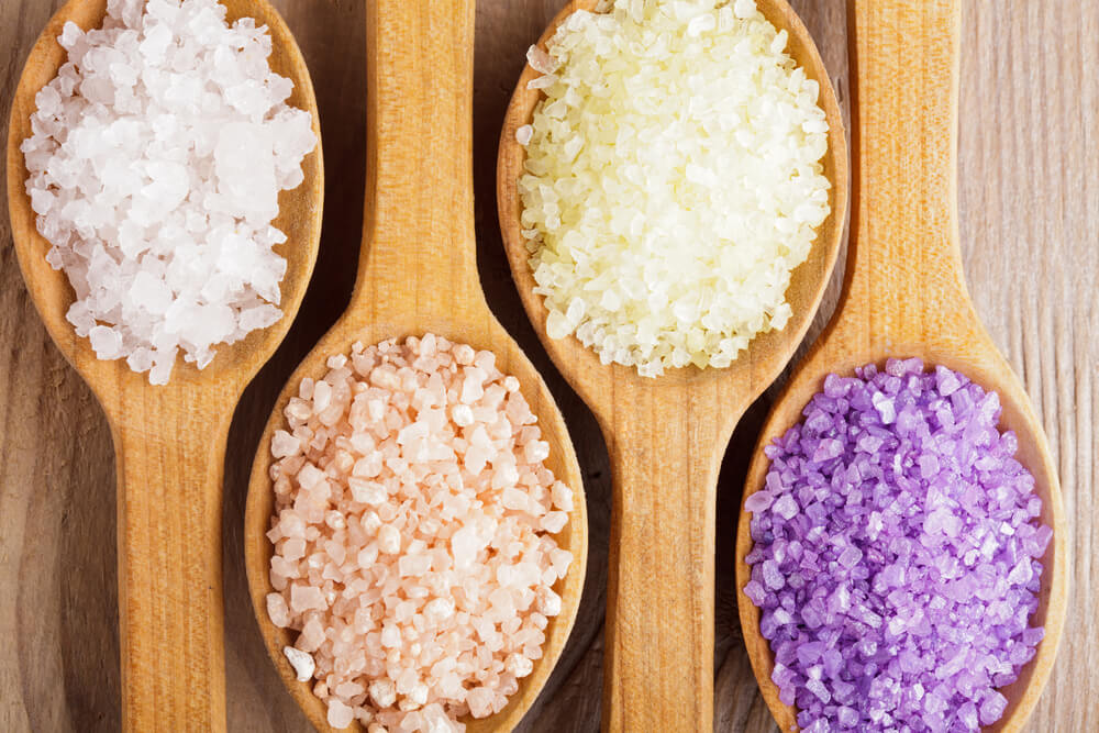 various bath salts on spoons