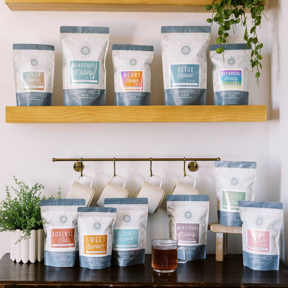Tea bags on shelves and a table with a plant and cup of coffee.