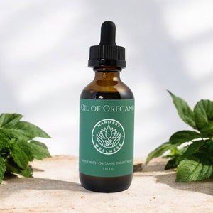 Bottle of Oil of Oregano from Manifester Wellness with green label and plants in the background